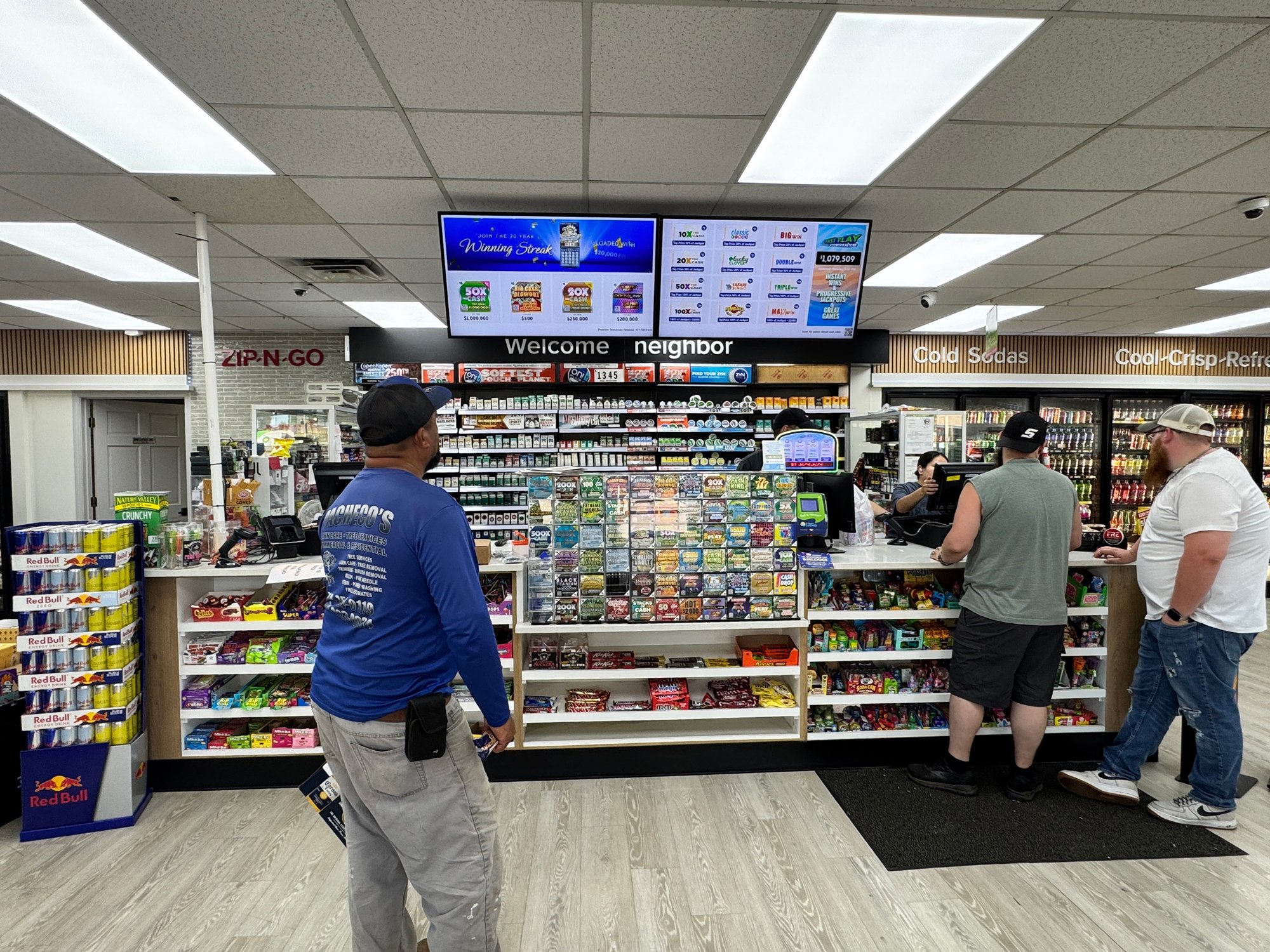 A person looking at a lottery screen inside a convenience store.